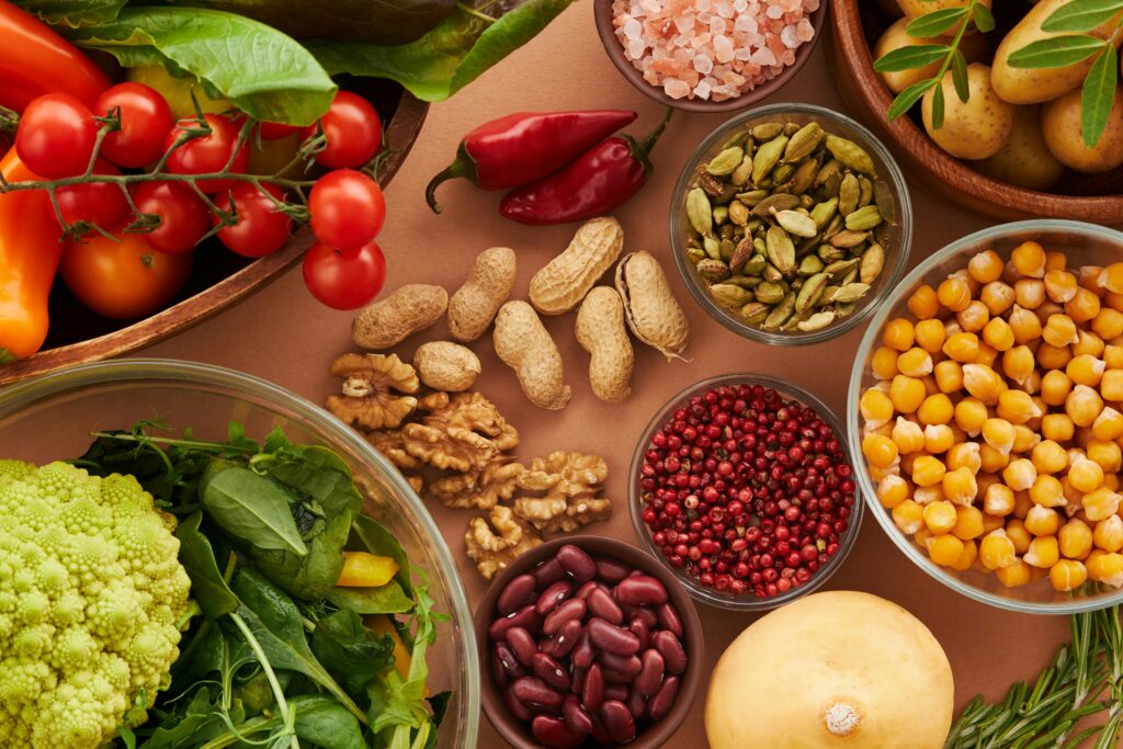 pexels-photo-5966149-5966149 Explore a colorful assortment of healthy ingredients, featuring vegetables, nuts, seeds, and spices in a top view layout.